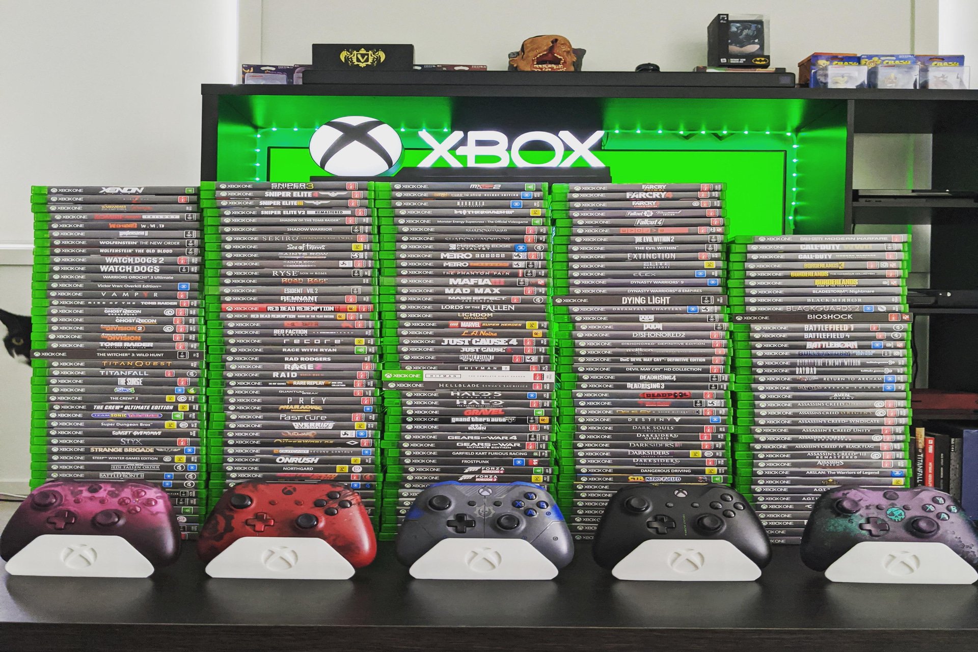 Xbox Physical game copies featured on a desk with multiple controllers